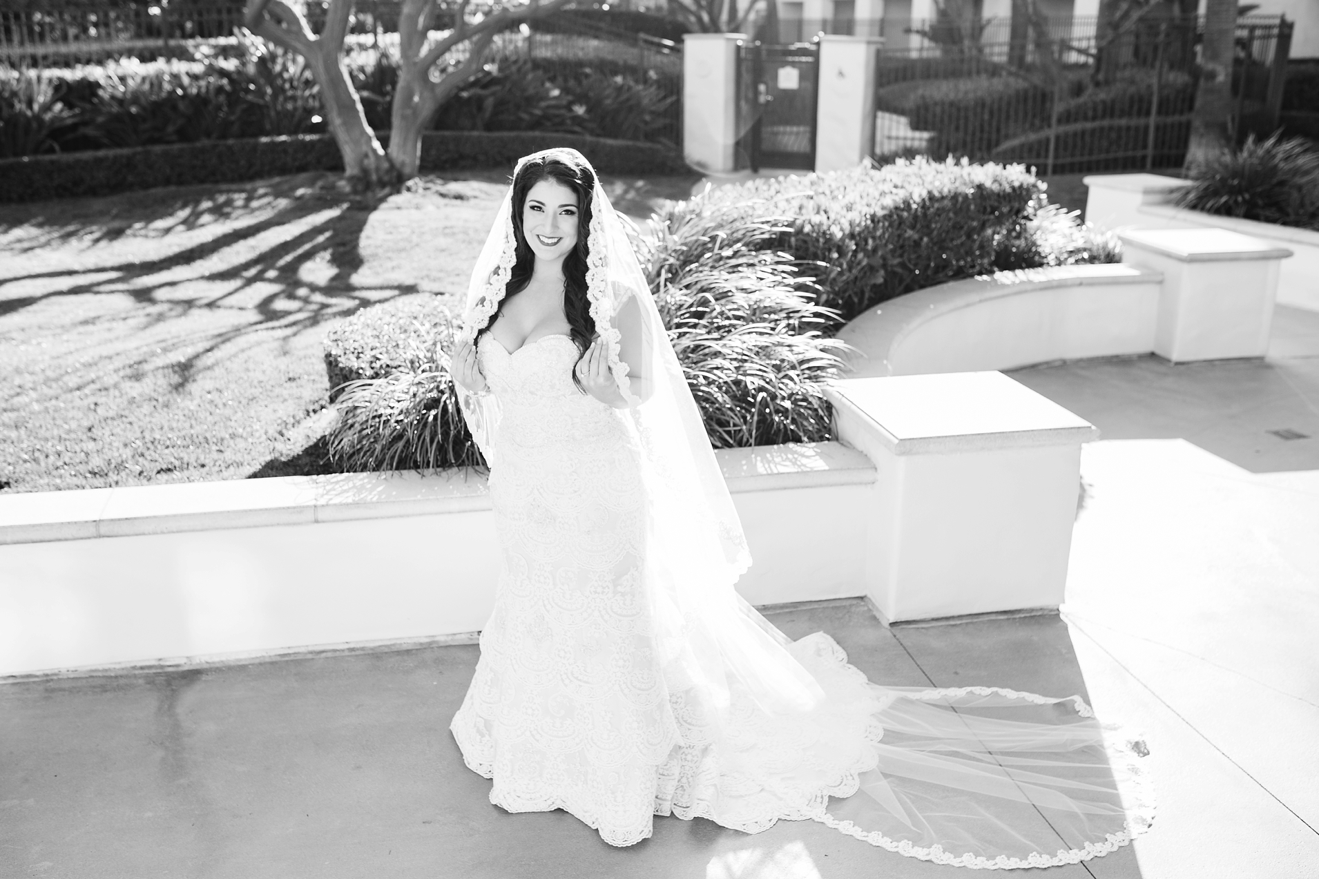 Black and White Photo of a beautiful bride with a long veil