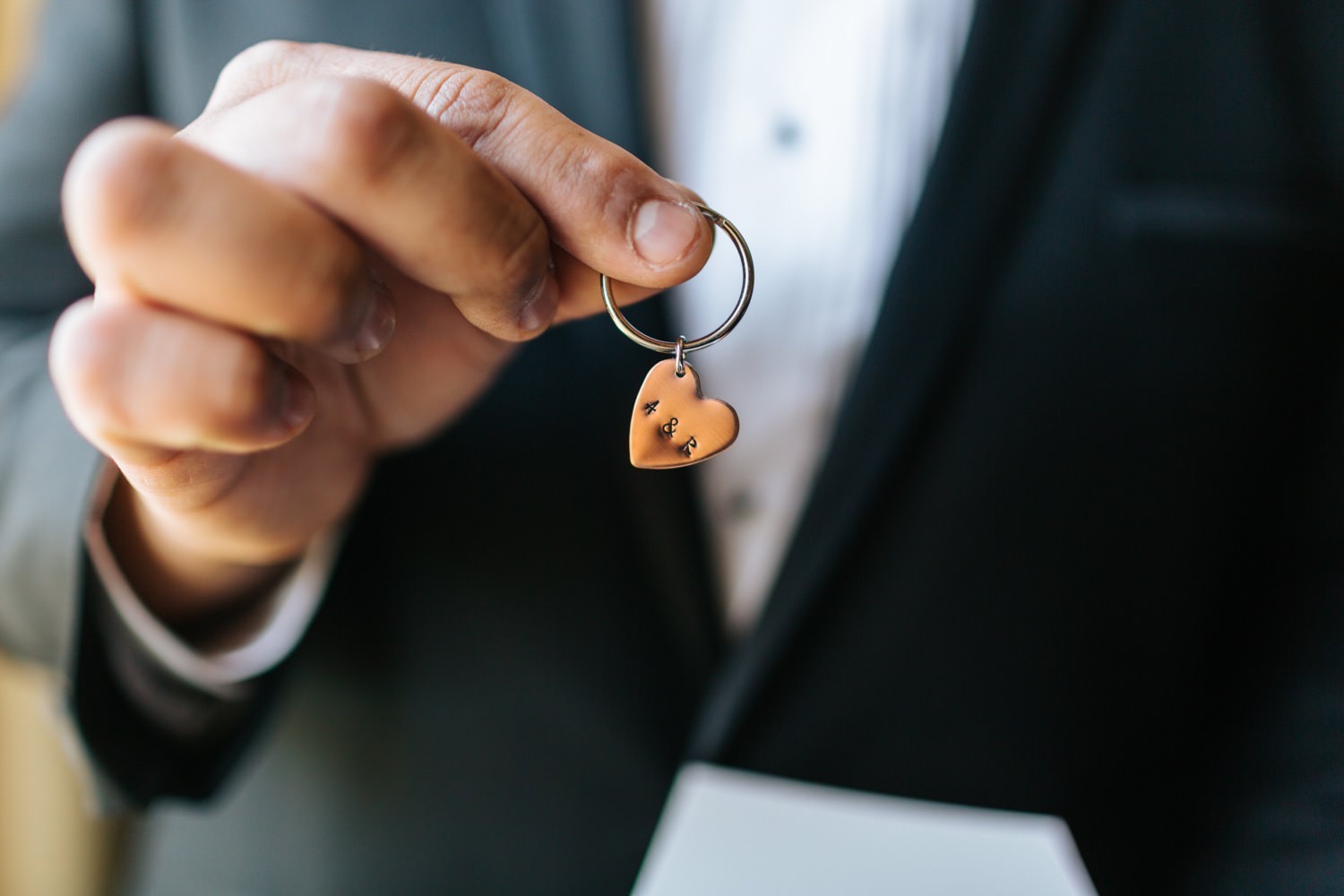 Groom opening gift from his bride - https://brittneyhannonphotography.com