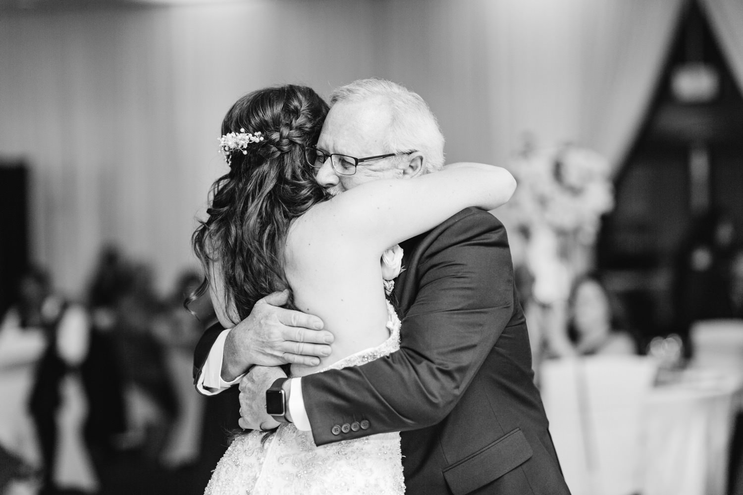 Bride hugs her dad after special father daughter dance - https://brittneyhannonphotography.com