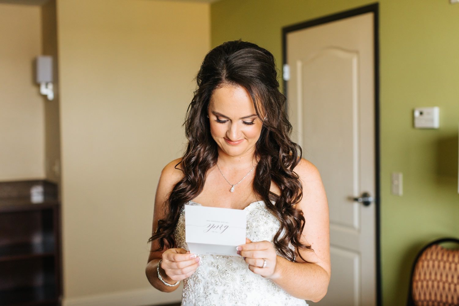 Bride reading letter from groom - https://brittneyhannonphotography.com