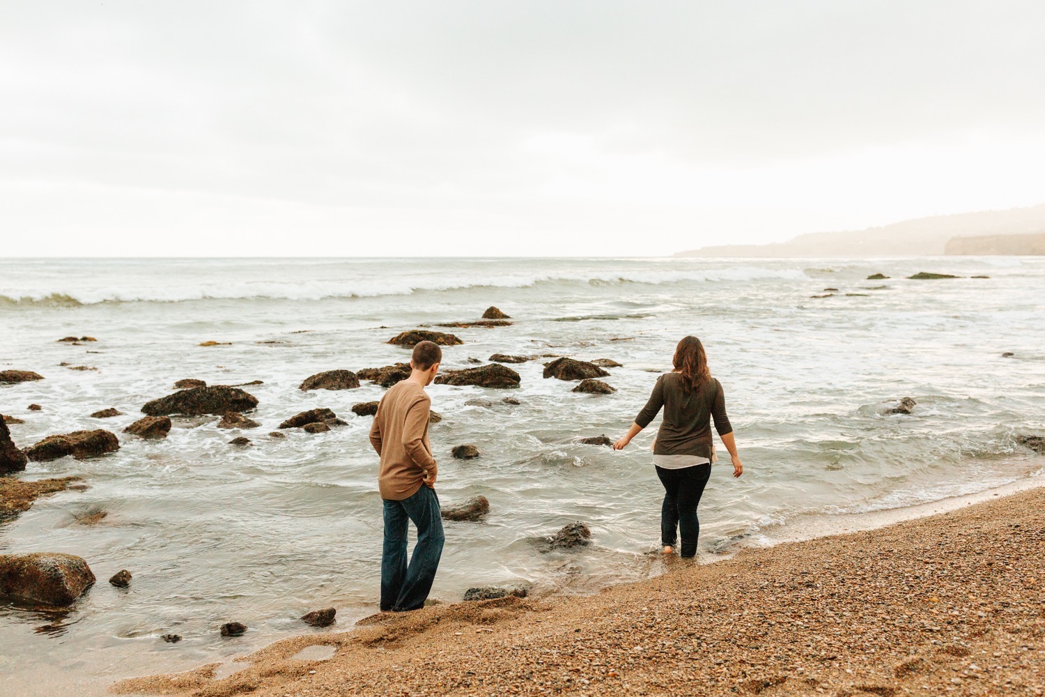 couple-playing-in-the-water-during-engagement-session